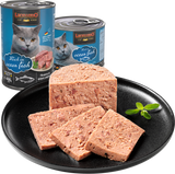 Leonardo cat food cans with ocean fish flavor and slices of cat food on a black plate.