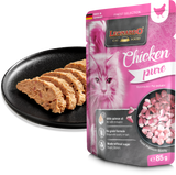 Leonardo cat food package with chicken pure flavor next to a black plate with cat treats.