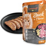 Leonardo cat food package with duck and cheese flavor next to a black plate with cat food slices.