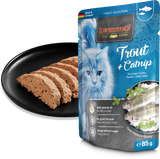 Leonardo cat food packet with cat illustration and text, next to a black plate with cat food slices.