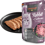 Leonardo cat food package with a black plate of cat treats on a white background