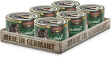 A pack of six cans of LEONARDO Turkey with Trout & Cranberries cat food, placed on a wooden tray with 'MADE IN GERMANY' printed on it.