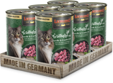 A pack of six cans of LEONARDO Turkey with Trout & Cranberries cat food, placed on a wooden tray with 'MADE IN GERMANY' printed on it.